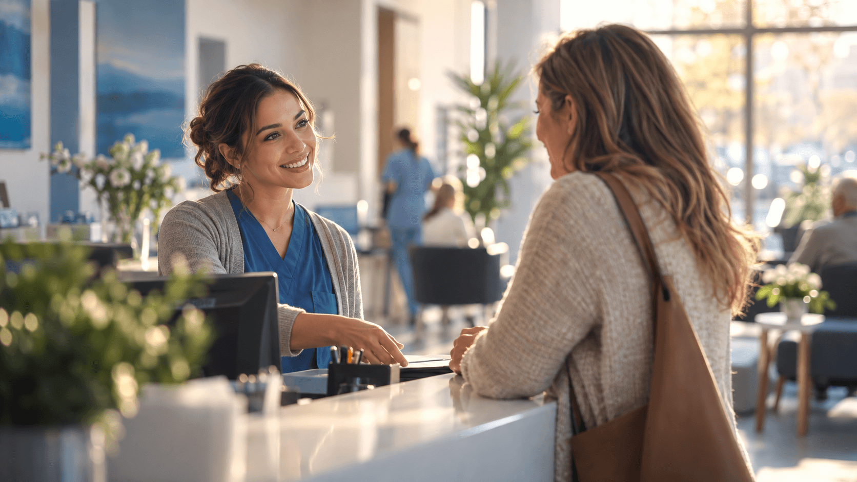 A medical receptionist welcoming an adult visitor at a bright clinic